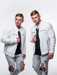Guys wear casual outfit. young confident brothers. confident fashion models. twins brother in white
