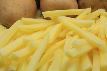 Close-up of Potatoes cut into strips and whole potatoes