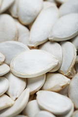 Pumpkin seeds in a shell close-up, macro as a background.