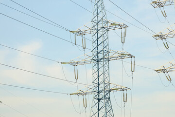 High-voltage power lines in the afternoon against the blue sky
