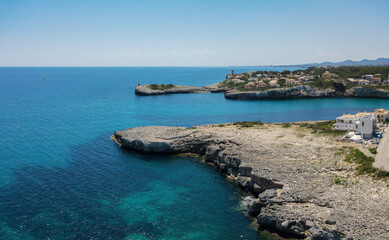 The port entrance of Porto Cristo on the Spanish Mediterranean island of Mallorca. It's summer with sunshine. In the background you can see the coastline to the south.