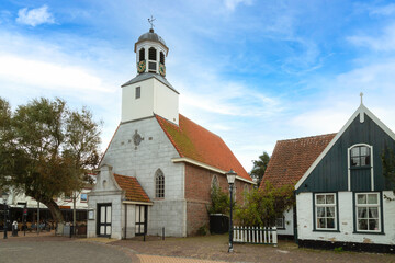 Reformed church in the center of the small touristic village De Koog on the Wadden Island of Texel, the Netherlands. - obrazy, fototapety, plakaty