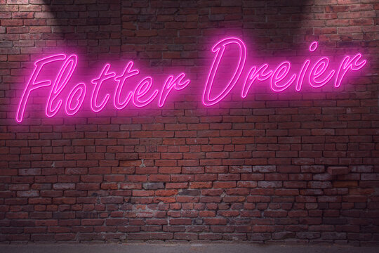 Neon Threesome (in german Flotter Dreier) lettering on Brick Wall at night