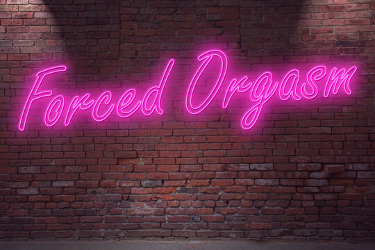 Neon Forced Orgasm (in german Orgasmus) lettering on Brick Wall at night
