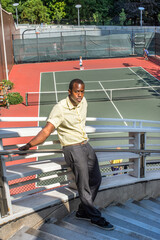 Young black man standing outdoors in New York City, thinking