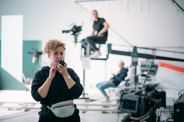 Director at work on the set. The director works with a group or with a playback while filming a movie, advertising