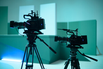 A professional film and video camera on the set. Filming day, equipment and crew. Technique of...