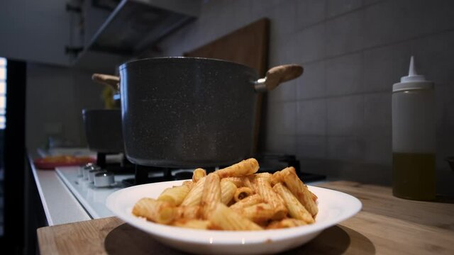 Serve delicious looking pasta on the plate. Tomato and meat ragu. Serve a professionally cooked pasta dish in the restaurant or for a romantic dinner at home. Slow motion close-up
