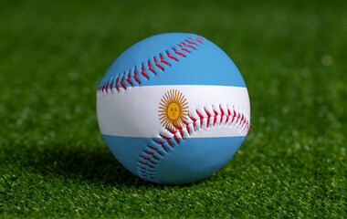 Baseball with Argentina flag on green grass background, close up