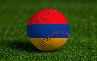 Baseball with Armenia flag on green grass background, close up