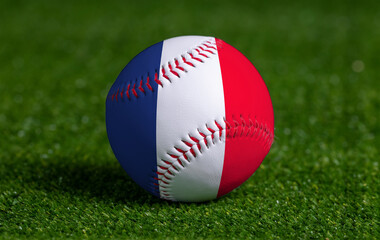 Baseball with France flag on green grass background, close up