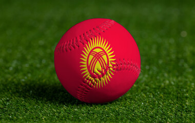 Baseball with Kyrgyzstan flag on green grass background, close up