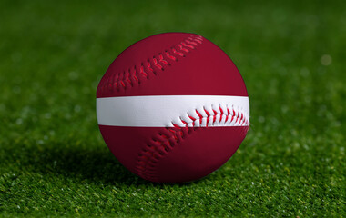 Baseball with Latvia flag on green grass background, close up