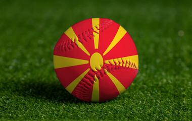 Baseball with Macedonia flag on green grass background, close up