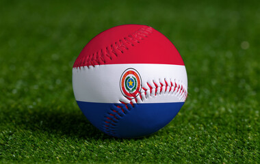 Baseball with Paraguay flag on green grass background, close up
