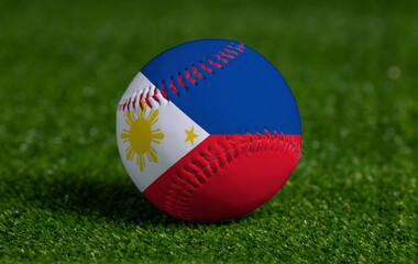 Baseball with Philippines flag on green grass background, close up