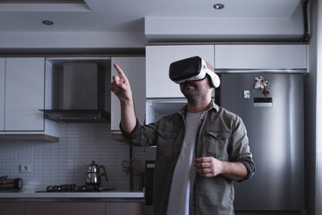 man wearing augmented virtual reality glasses in the kitchen