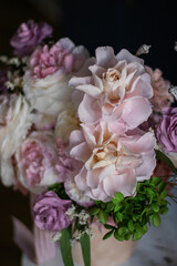 Beautiful flowers. Preserved roses with dried flowers bouquet closeup. Beautiful flower arrangement in a pink box.