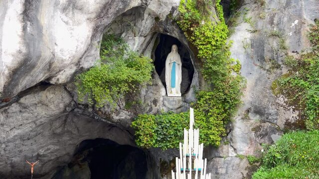 Lourdes, France - August 28, 2021: A statue of the virgin Mary in the holy cave - grotto of Lourdes, the place of Marian apparitions.
