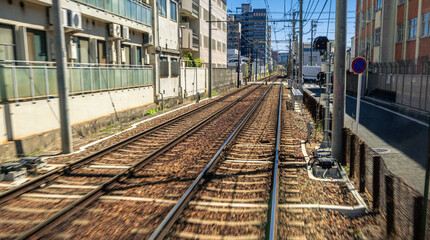 Japanese Kyoto local train traveling on rail tracks along the railway. Japan