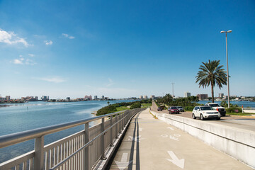 Wonderful panorama of blue sky, road and palm trees, Tampa Bay Bridge.