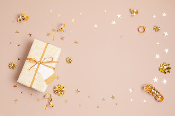 Christmas background with gift boxes wrapped in golden colored paper. Xmas celebration, preparation for winter holidays. Festive mockup, top view, flat lay