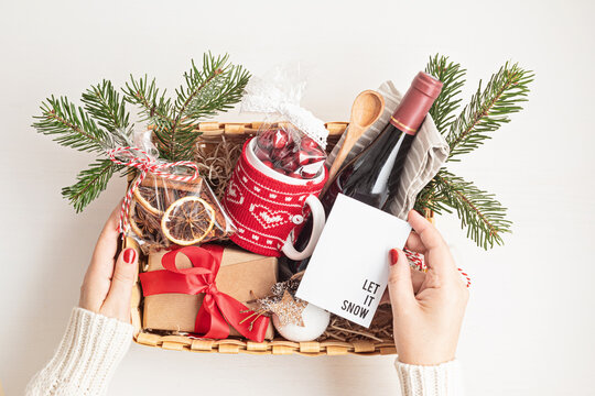 Refined Christmas gift basket for culinary enthusiats with bottle of wine and mulled wine ingredients. Corporate hamper or personal present for cooking lovers, foodies and gourmands.