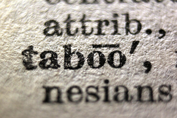 Word "taboo" printed on dictionary page, macro close-up