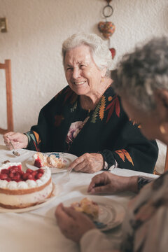 Senior woman with female guest celebrating birthday
