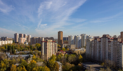 Fototapeta na wymiar Cityscape - panoramic view of modern multi-storey buildings and colorful autumn trees on a sunny, clear day in Reutov, Russia.