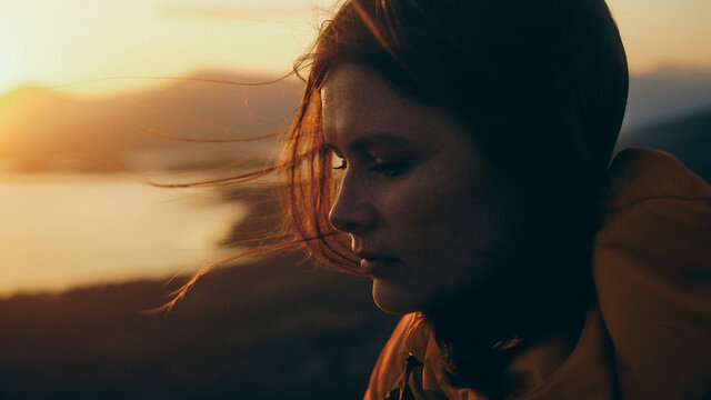 portrait of a woman at sunset in the mountains