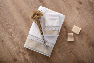 white bathroom towels on wooden background