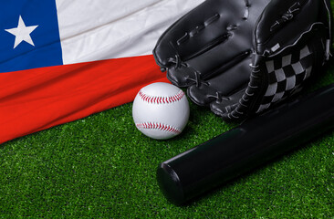 Baseball bat, glove and ball near Chile flag on green grass background