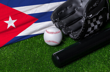 Baseball bat, glove and ball near Cuba flag on green grass background