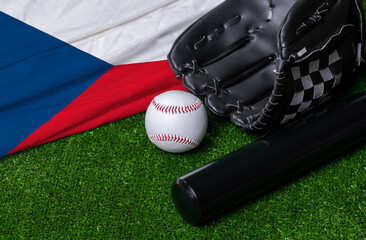 Baseball bat, glove and ball near Czech republic flag on green grass background