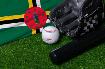 Baseball bat, glove and ball near Dominica flag on green grass background