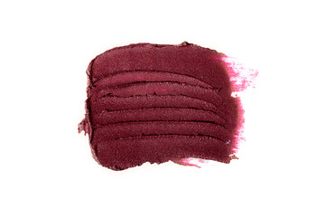 Smear of burgundy lipstick,isolated on white.Cosmetics background with negative space.