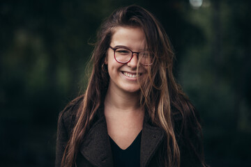 Beautiful young woman wearing glasses and a coat