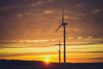Electric wind turbines farm sunset