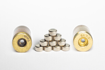 Reloading/handloading - closeup of 9mm brass/casing showing dirty(Left) and cleaned(Right) primer...
