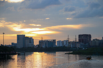 Fototapeta na wymiar Lake view of Dhaka city with skyline buildings in the evening