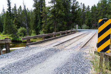 Newly graded gravel road over a bridge spanning the Little Popo Agie River outside of Lander, Wyoming © MelissaMN
