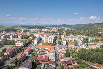 Fototapeta na wymiar Aerial view of Filakovo town with partially restored medieval castle surrounded by communist style block house and modern center in Southern Slovakia old versus new contrast