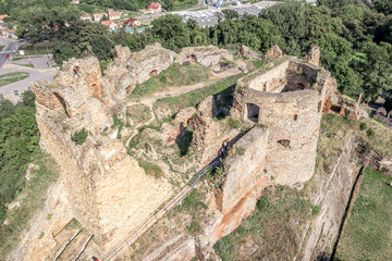 Aerial view of partially restored medieval Filakovo Fulek castle in Southern Slovakia with cannon...