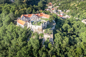 Aerial panoramic view of Gothic hilltop ruined castle Kekko, Modry Kamen or Blue Stone, in Southern Slovakia above a village