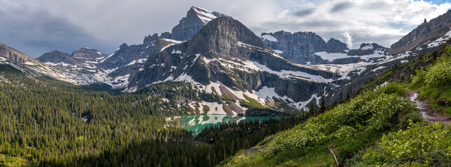 Spring Mountain Trail - A panoramic Spring evening view of Mt. Gould, Angel Wing and Grinnell Lake, as seen from Grinnell Glacier Trail. Many Glacier, Glacier National Park, Montana, USA.
