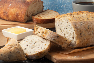 Sliced fresh baked breads on cutting board.