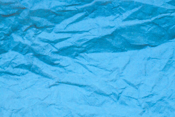 Fototapeta premium Blue crumpled paper background.