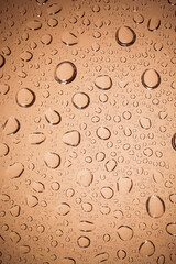 water drops on Brown glass background.
