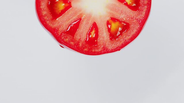 Beautiful red slice tomato rotating. Copy space.